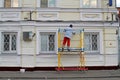 Builder worker painting facade of building with roller Royalty Free Stock Photo