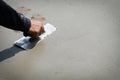 Builder worker plastering concrete cement floor.Hands Plasterer at work Royalty Free Stock Photo