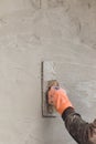 Builder worker plastering concrete