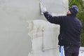 Builder worker plastering facade