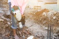 Builder worker with pneumatic hammer drill equipment breaking asphalt at construction site Royalty Free Stock Photo