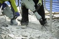 Builder worker with pneumatic hammer drill equipment breaking Post tensioned Slab To change the sling,  Concrete floor repair at Royalty Free Stock Photo