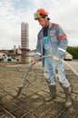 Builder worker pouring concrete