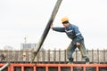 Builder worker pouring concrete into form