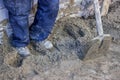 Builder worker tamping sand bedding with a feet 2 Royalty Free Stock Photo