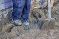 Builder worker tamping sand bedding with a feet Royalty Free Stock Photo