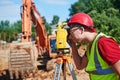 Surveyor worker with theodolite at construction site Royalty Free Stock Photo