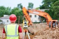 Surveyor worker with theodolite at construction site Royalty Free Stock Photo