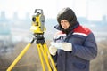 Surveyor worker with theodolite at construction site Royalty Free Stock Photo