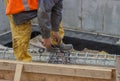 Builder worker tying a spacer to a rebar 2