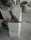 builder worker use stainless steel ruler measure lightweight cement brick prepare for cut to install wall