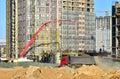 Builder workers during formworks and pouring concrete through a ÃÂoncrete pump truck connected to a ready-mixed truck. Concrete