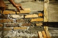 Builder layering cemented bricks structure Royalty Free Stock Photo