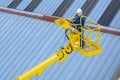 Builder on yellow aerial platform