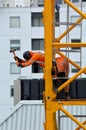 Builders assemble a construction tower crane