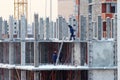 Builders in blue clothes on construction of building