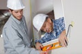 Builders checking work with spirit level Royalty Free Stock Photo