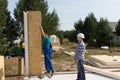 Builders erecting insulated wall panels