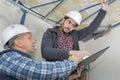 Builders fastens profile using cordless screwdriver Royalty Free Stock Photo