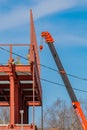 Builders fix iron beams with a crane. Frame construction. Moscow Russia April 14, 2022