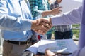 Builders Handshake Closeup, Two Building Business Men Making Deal After Discussion Of Blueprint To New Project With