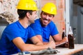 Builders having break on construction site Royalty Free Stock Photo