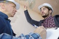 Builders inspecting roof damage Royalty Free Stock Photo