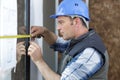 Builders installing measuring windows Royalty Free Stock Photo