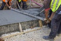 Builders level wet concrete with a metal screed 2 Royalty Free Stock Photo