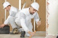 builders removing old floor tiles using hammer and chisel Royalty Free Stock Photo