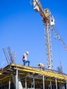 Builders on the roof of a house under construction. Construction industry. Workers at work. Construction of a new house