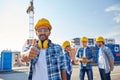 Builders showing thumbs up at construction site