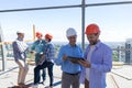 Builders On Site Holding Tablet Computer Discuss Construction Project Over Team Of Apprentices Talking Royalty Free Stock Photo