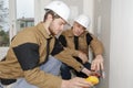 Builders using yellow multimeter to calibrate house