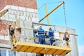 Builders worker installing glass windows on facade Royalty Free Stock Photo