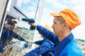 Builders worker installing glass windows on facade Royalty Free Stock Photo