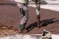 Builders works on the construction site: pouring brown concrete for foundation