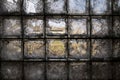 Building of an abandoned and destroyed farm is seen through a partially broken, dirty window of glass blocks in the village. Royalty Free Stock Photo