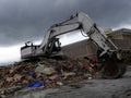 Building being demolished by a powerful excavator Royalty Free Stock Photo