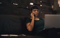 Building a blacksmithing business takes a will of steel. a young woman using a laptop and smartphone while working at a