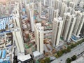 Aerial view of massive identical buildings site in construction with tower crane.