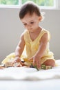 Building blocks of young education. a cute baby girl sitting on the floor playing with toys. Royalty Free Stock Photo