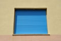 a building with a blue roller door and the windows closed Royalty Free Stock Photo