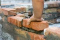 Building brick block wall on construction plant. Worker builds a brick wall in the house. Construction worker laying bricks on ext