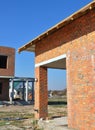 Building brick wall house with wooden roof rafters and rigid insulation wall thermal bridge. Royalty Free Stock Photo