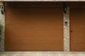 Building with brown roller shutter garage door Royalty Free Stock Photo