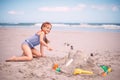 Building the castle of her dreams. Portrait of a little girl building a sandcastle at the beach. Royalty Free Stock Photo