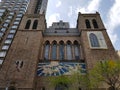 The building of the cathedral in New York of brick in good weather.