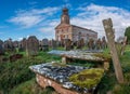 Building and cemetery stones of Kirkandrews under the blue sky with clouds in Carlisle