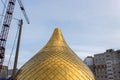 Building a church, consruction site. Golden dome of the Orthodox church in Central Russia on the blue sky background. Close up sho Royalty Free Stock Photo